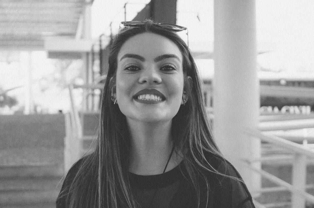 Portrait of a woman with long dark hair smiling